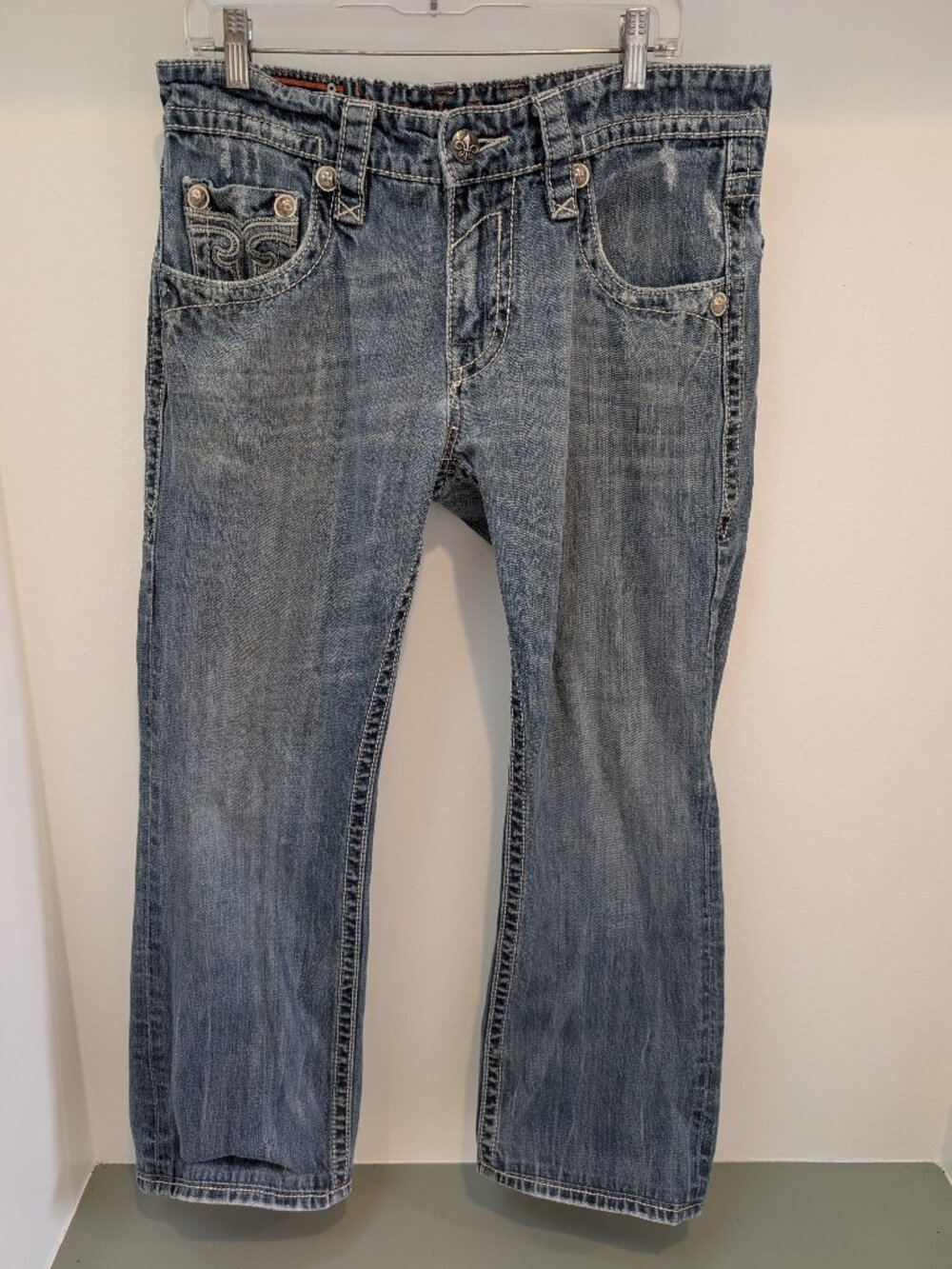 Rock Revival Boot Cut Bling Jeans with Decorative Stitching and Custom Buttons.